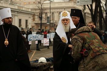 Euromaidan activist kisses the hand of Filaret the Patriarch of Kyiv